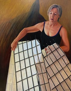 Selp portrait of Josonia Palaitis holding a broken rice paper screen wearing a black singlet with an ominous shadow in the background